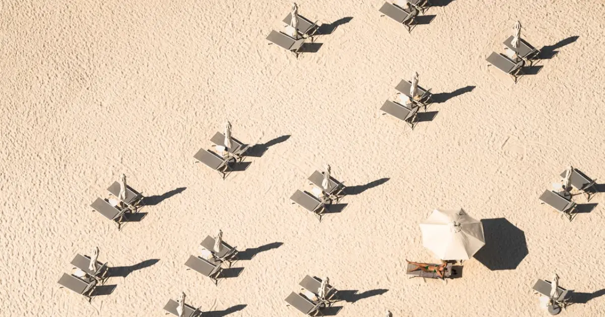 empty sunbeds and umbrellas on a sandy beach
