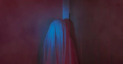 A Mysterious Object Covered by a Sheet Against a Wall in escape room