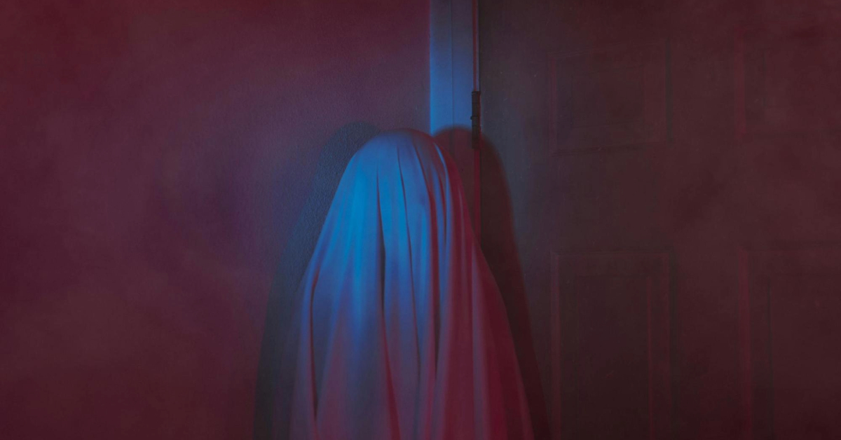 A Mysterious Object Covered by a Sheet Against a Wall in escape room