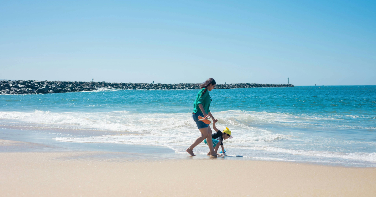 A boy and his mother at the beach