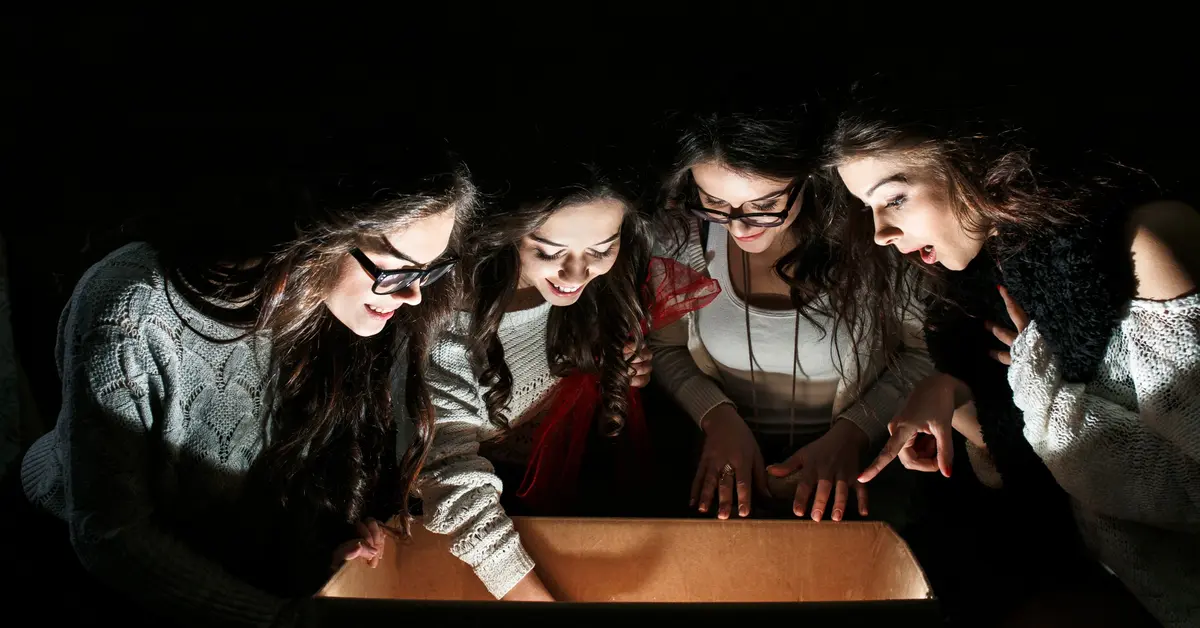 Amazed teens examining an open box