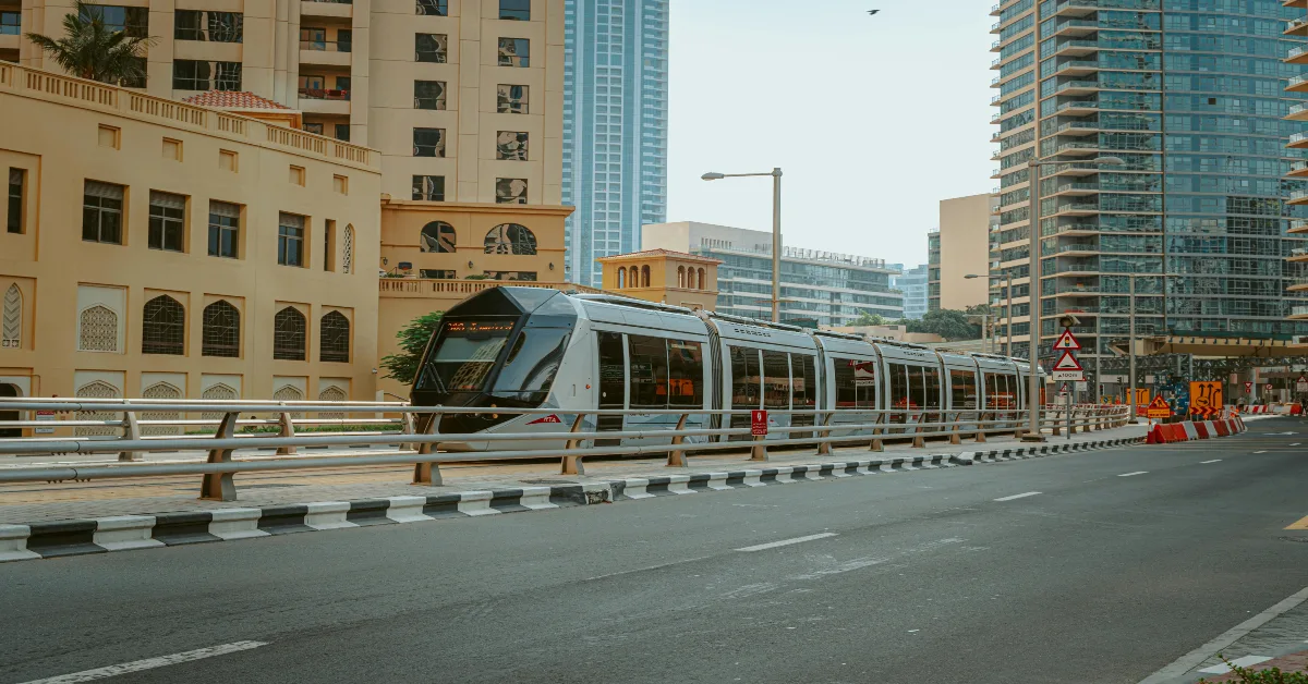A Tram in the Middle of the Road Near Buildings