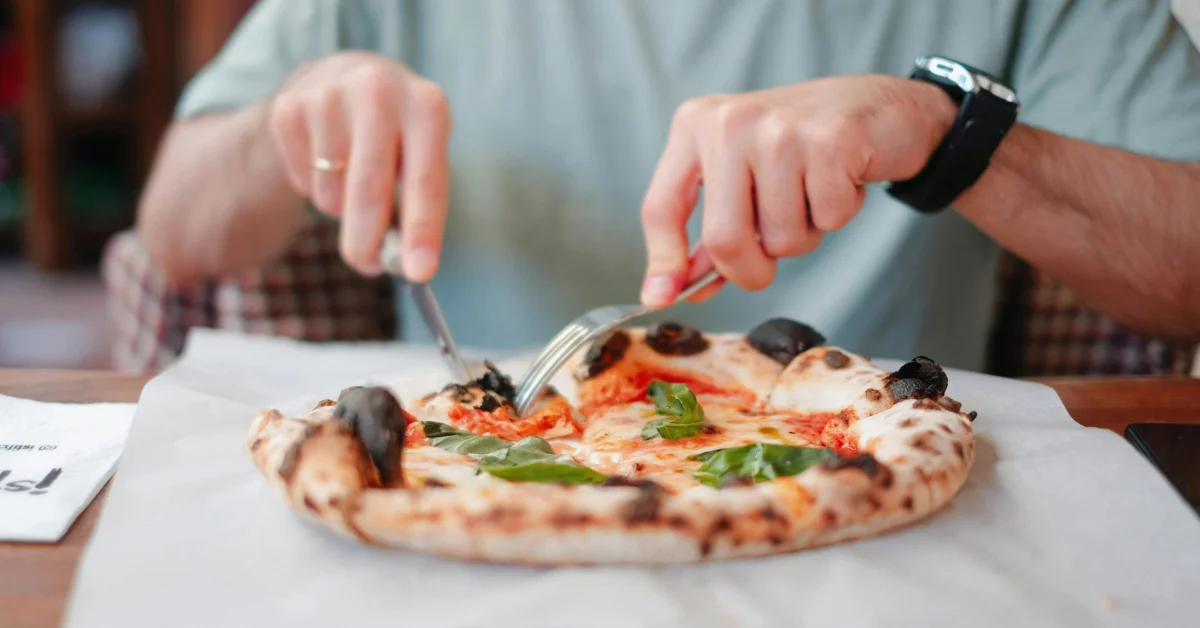 A man eating a pizza in a restaurant
