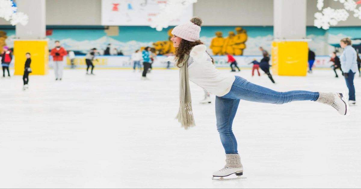 A young girl showing off her skating skills , gliding confidently across the rink