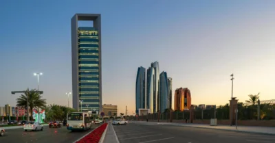 Stunning view of Abu Dhabi's skyline with skyscrapers and traffic at sunset