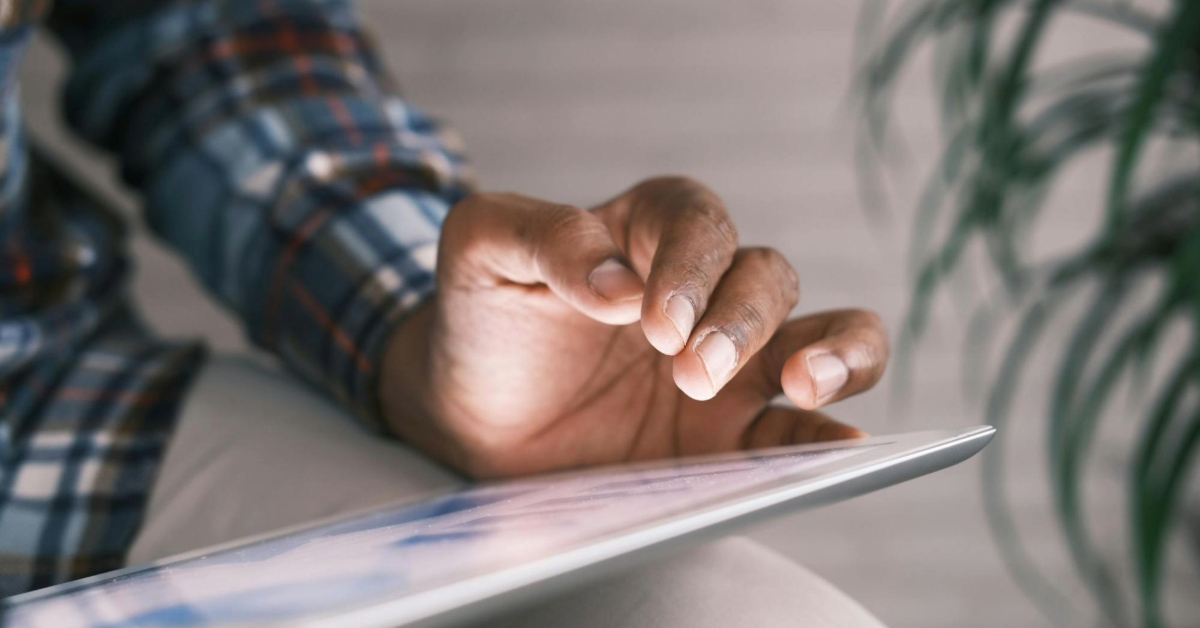 A person checking an ADDC utility bill on a digital tablet