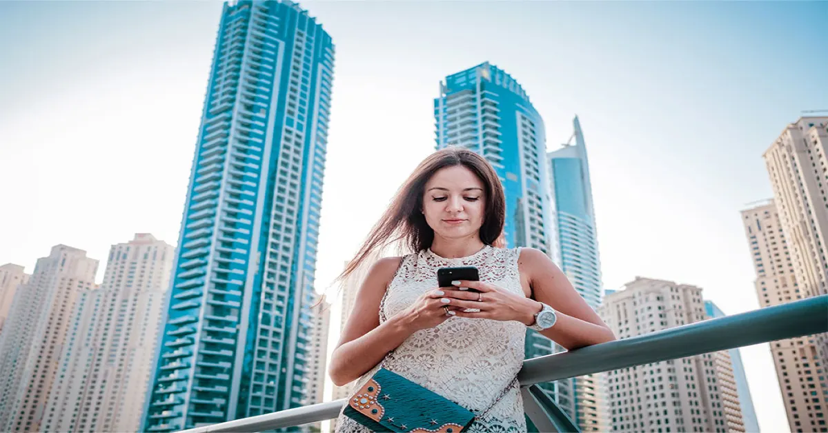 A woman sending SMS to secure a parking spot
