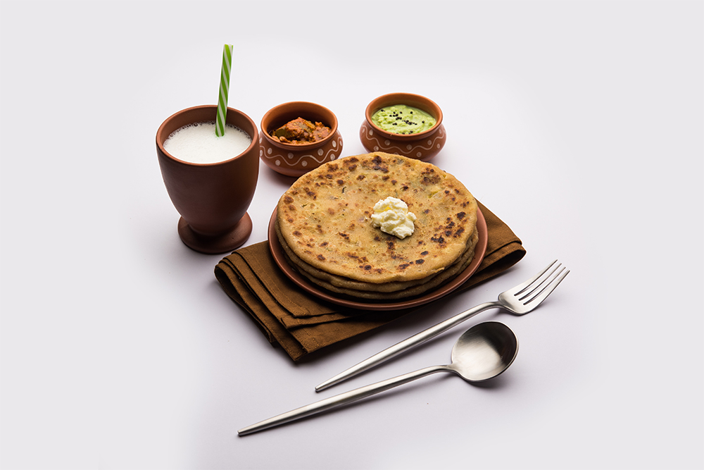 Typical Punjabi Indian food; Aloo Paratha with Lassi 
