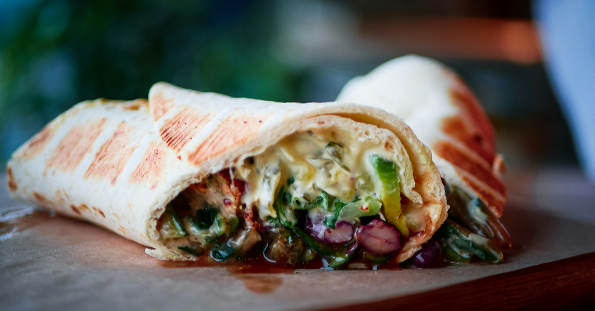 A large shawarma wrap cut neatly into perfect halves