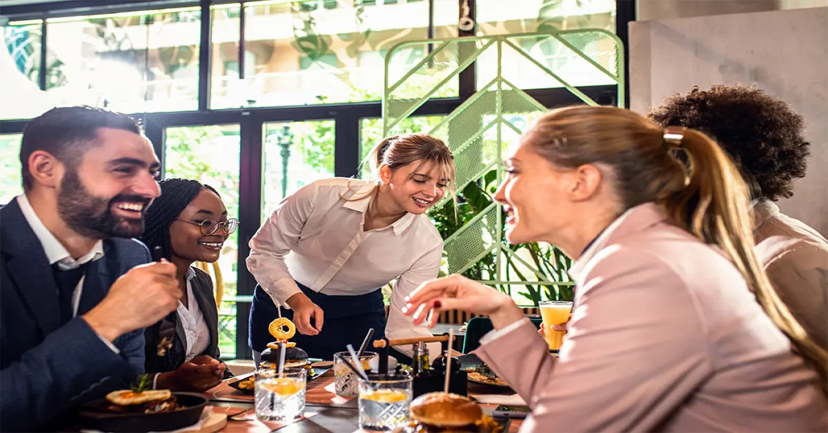 A group of people eating burger at a restaurant