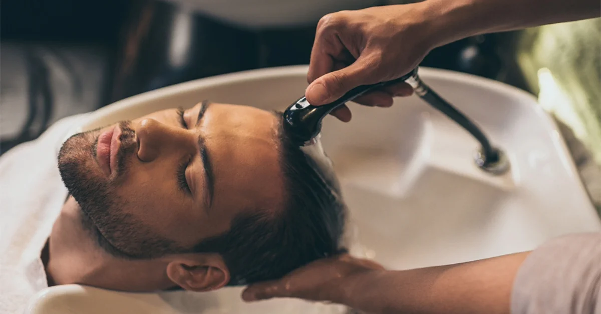 Barber washing a client's hair