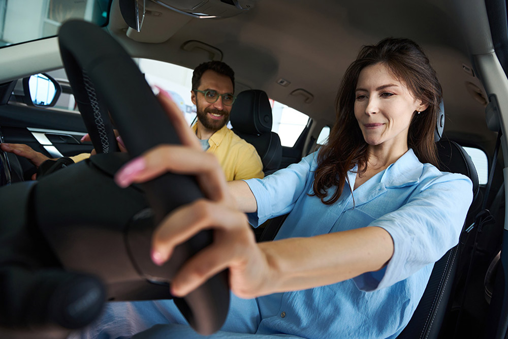 An excited learner with a driving instructor