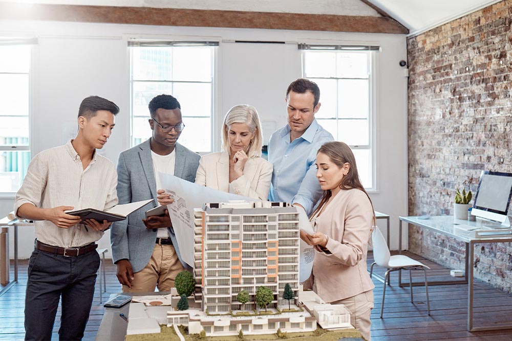 A team discussing commercial real estate investing with a client