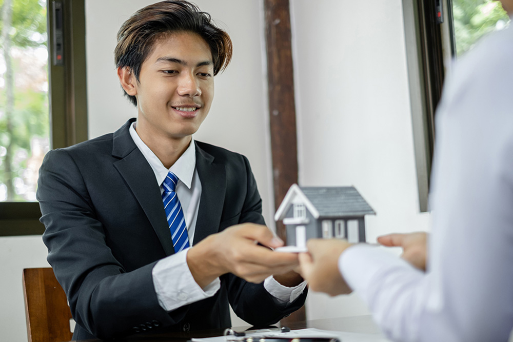  Real estate agent showing different house models
