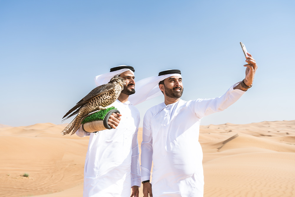 Tourists taking pictures with a falcon 