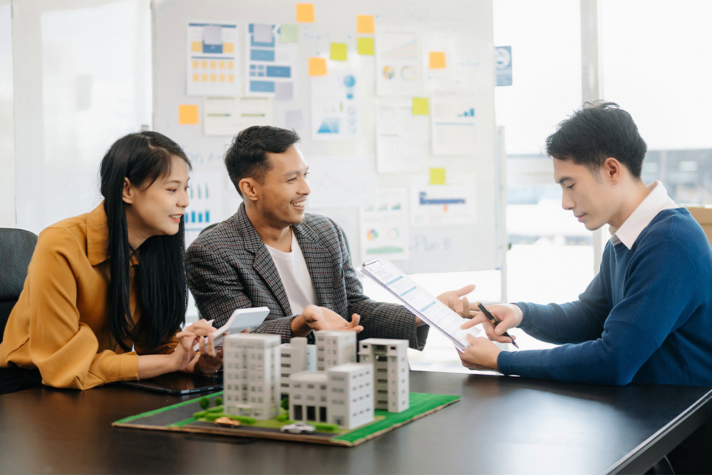 Investors discussing a commercial real estate investment plan
