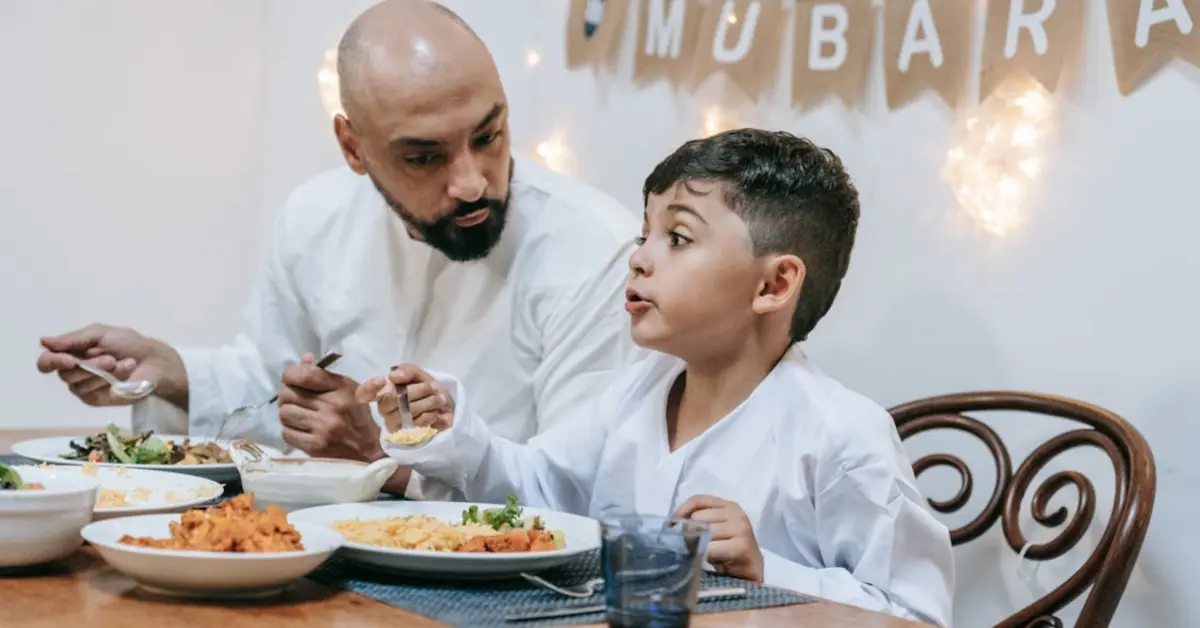A Man Eating with His Son