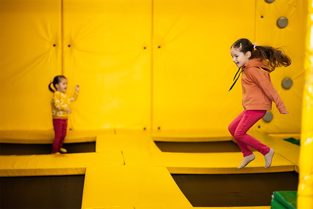 kids jumping in a trampoline park 
