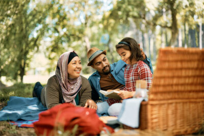 A family enjoying a picnic at Ghabat Al Regayeb Park in Ajman