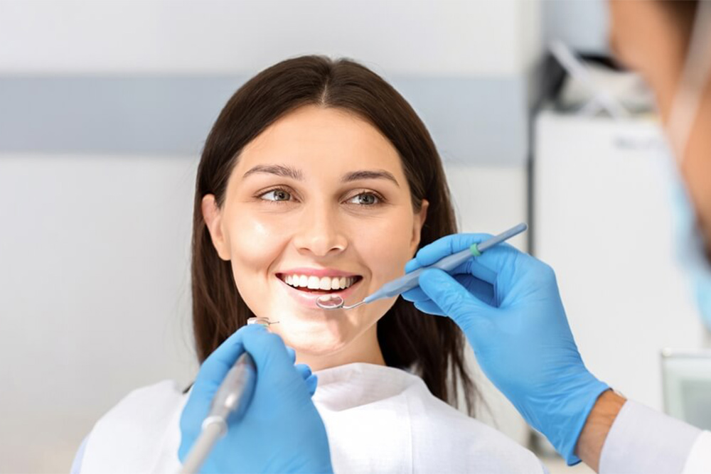 Dentist checking women’s teeth