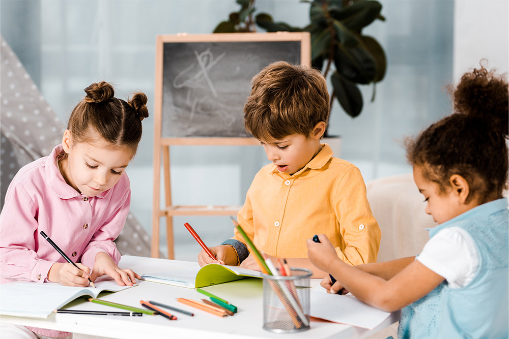 Little kids with varying cultural backgrounds studying together 