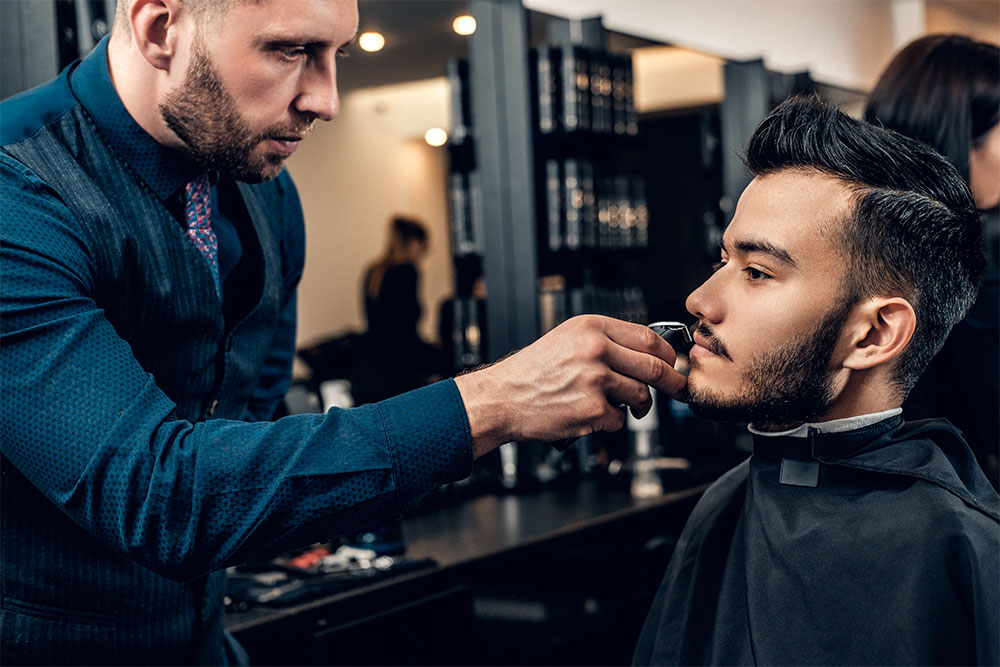 Man Trimming Beard of a Client