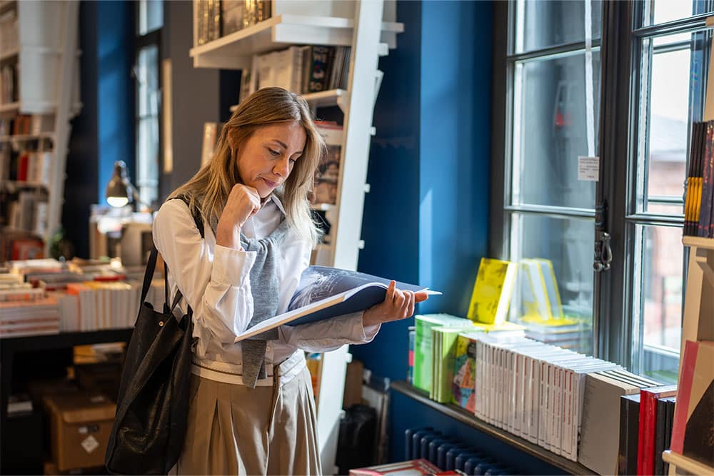 Women reading a book in a university bookshop in the UAE