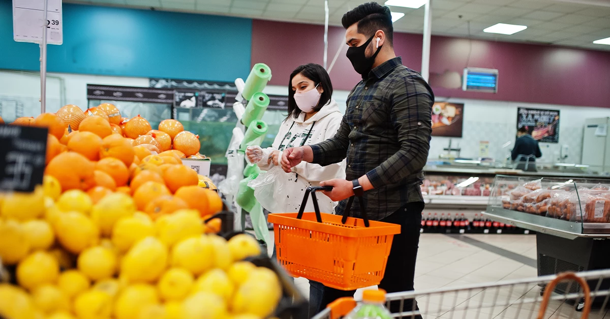 A couple doing grocery shopping at a supermarket in Al Mowaihat