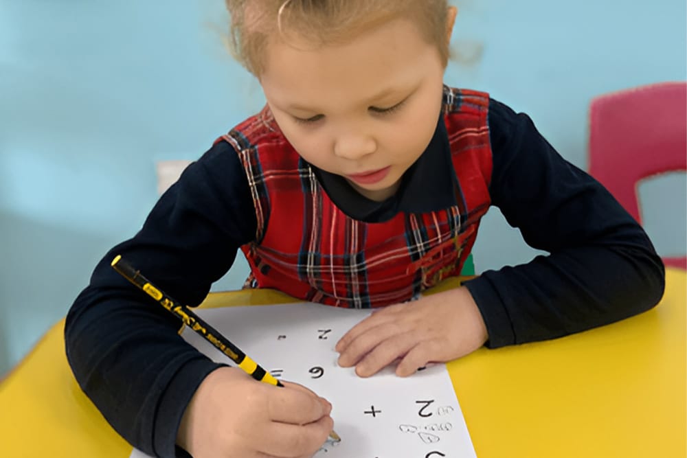 A girl solving Math problems at Kinderville Early Learning Centre in Karama, Dubai