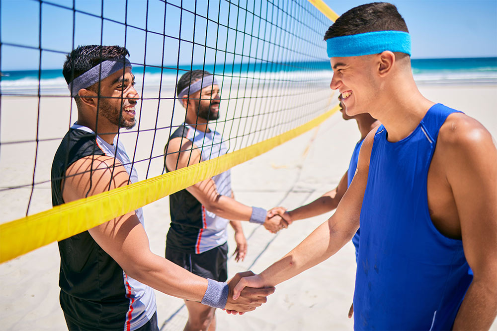 Friends playing volleyball at a waterpark