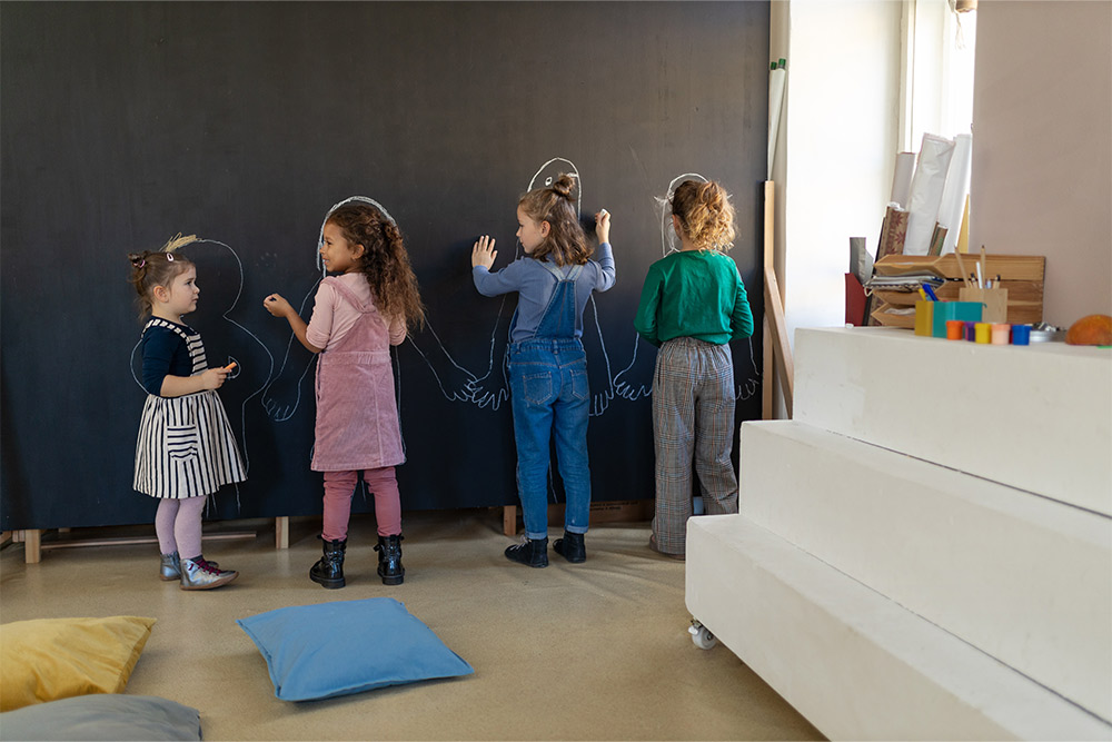  Kids expressing their creativity on a blackboard