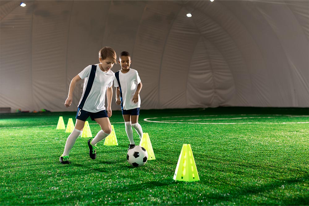 Kids Having Football Training in a Dome