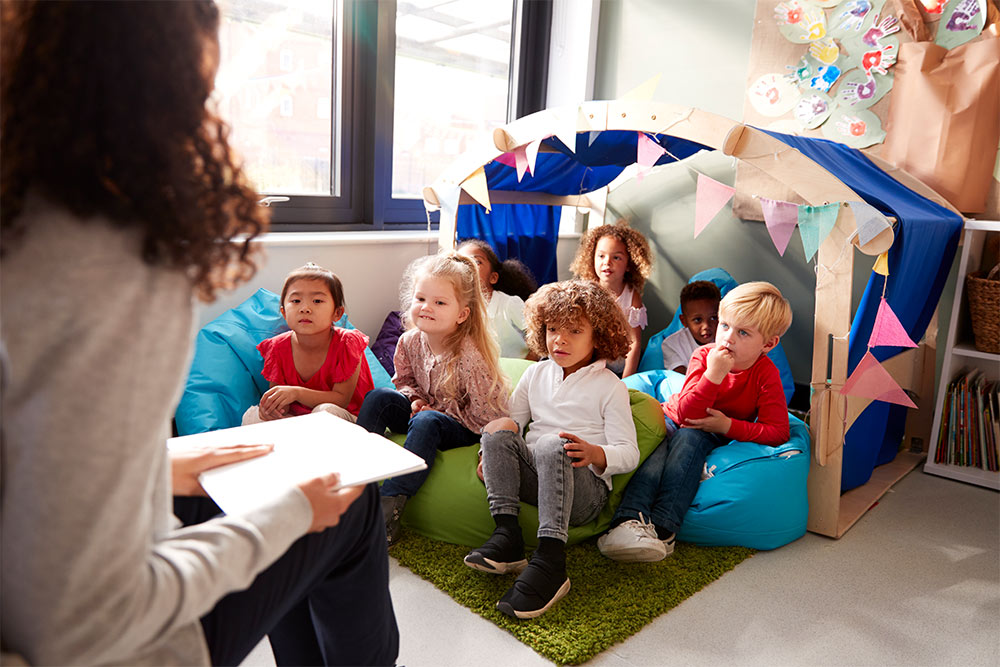 A qualified teacher telling stories to a group of students