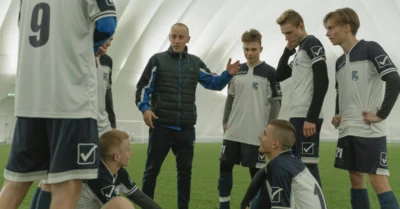 Football coach talking to his team