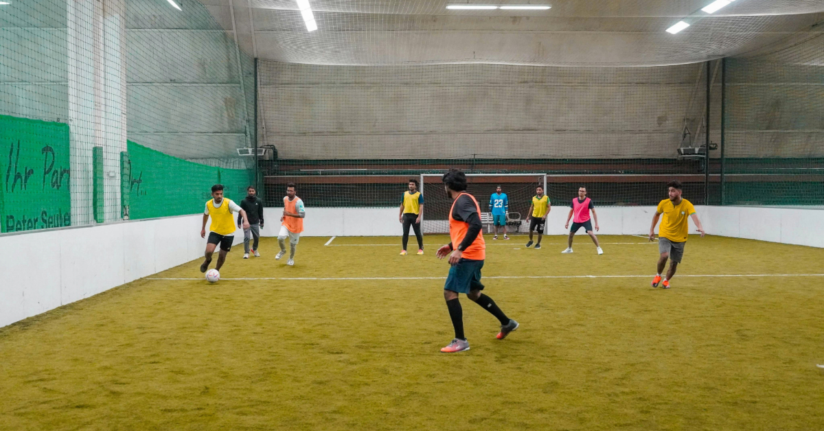 Men playing football indoors