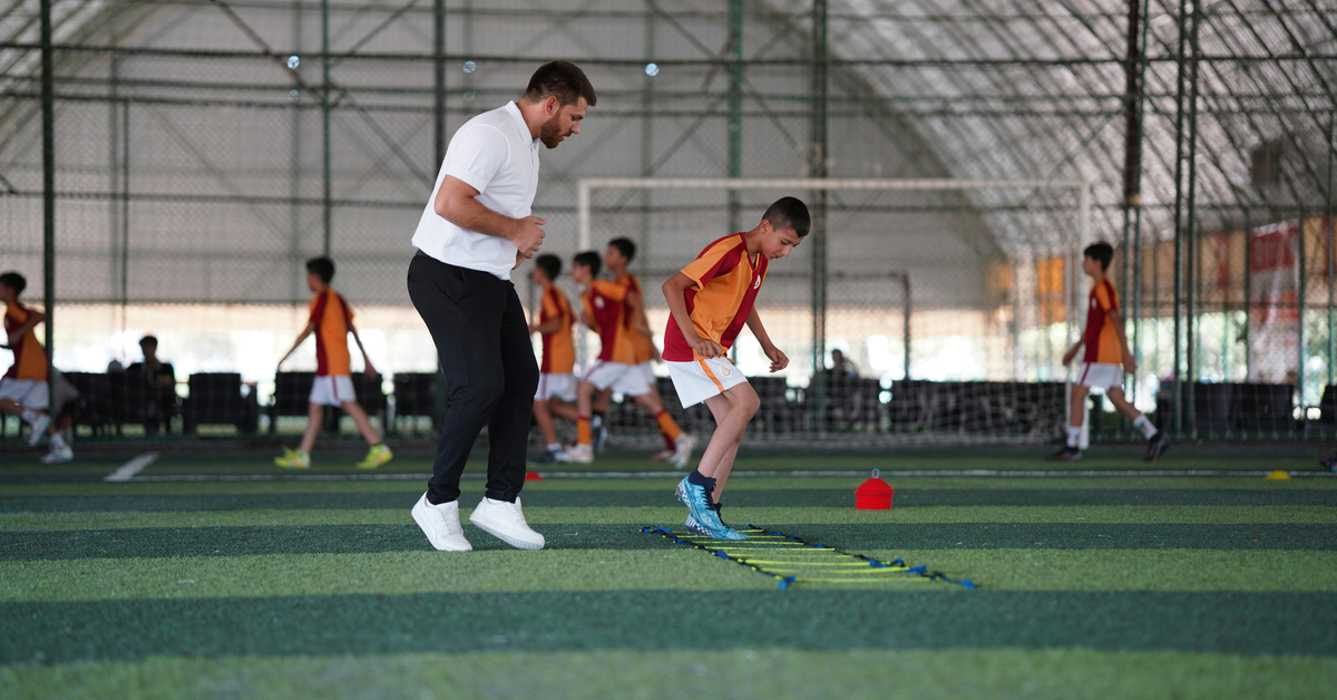 Men practising football indoors