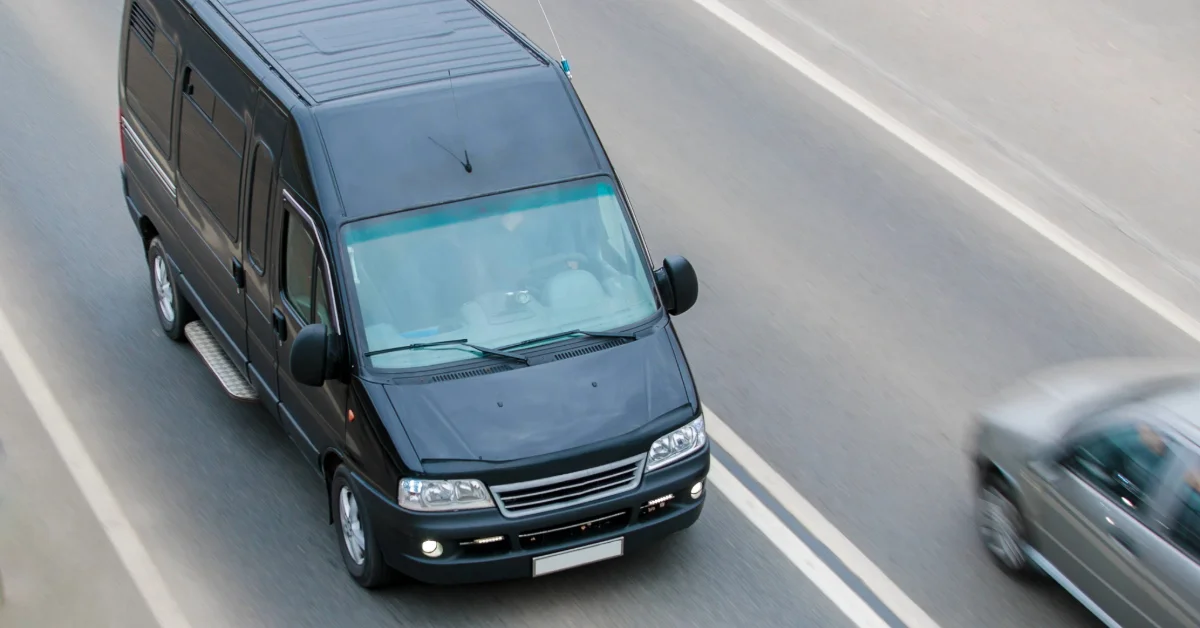 black minibus goes on a suburban highway