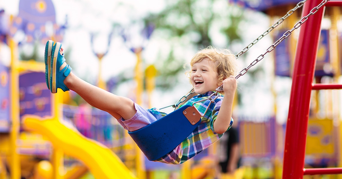 A child on a swing in one of the top nurseries in Jumeirah