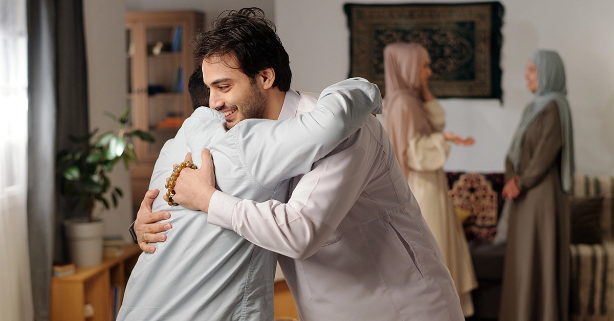 Muslim men greeting each other Eid Al Adha Mubarak