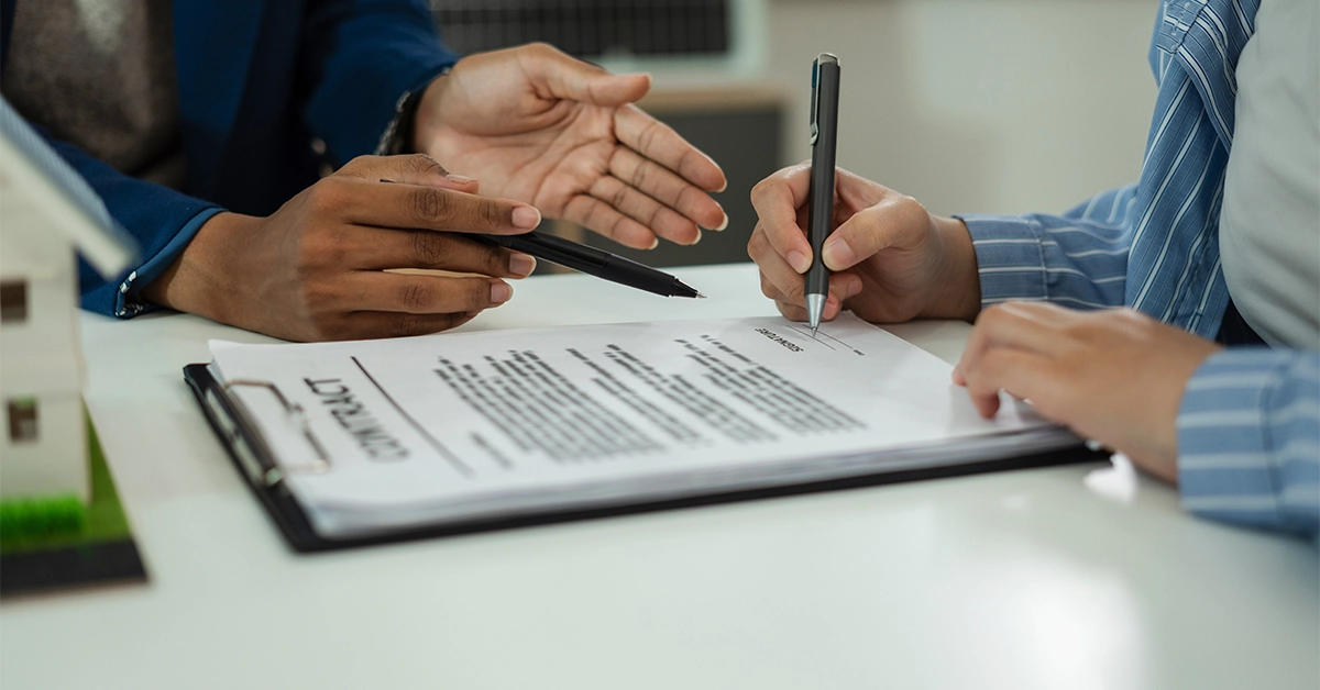 An owner signing an application for a lease to own transfer in Dubai 