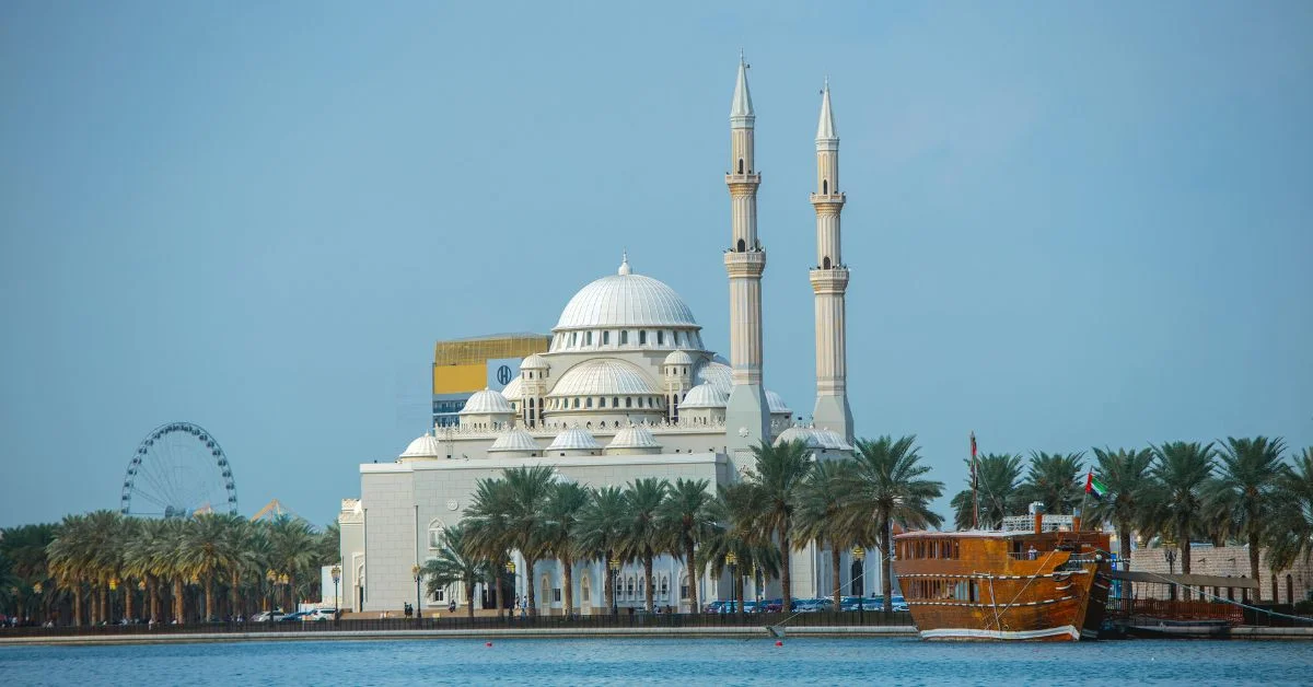 Large mosque surrounded by palms and sea