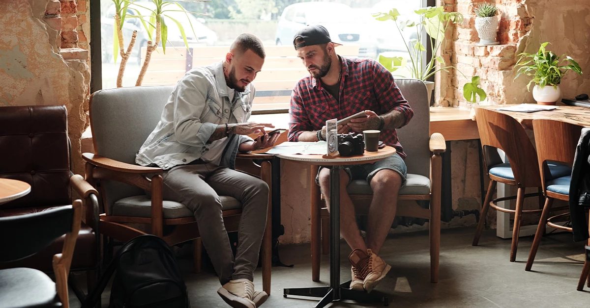 Two friends having a conversation in one of the best cafes in Dubai Creek Harbour 