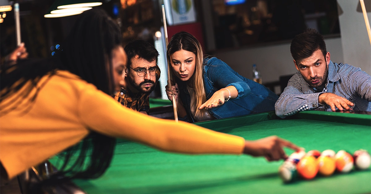 Friends playing billiards in Abu Dhabi