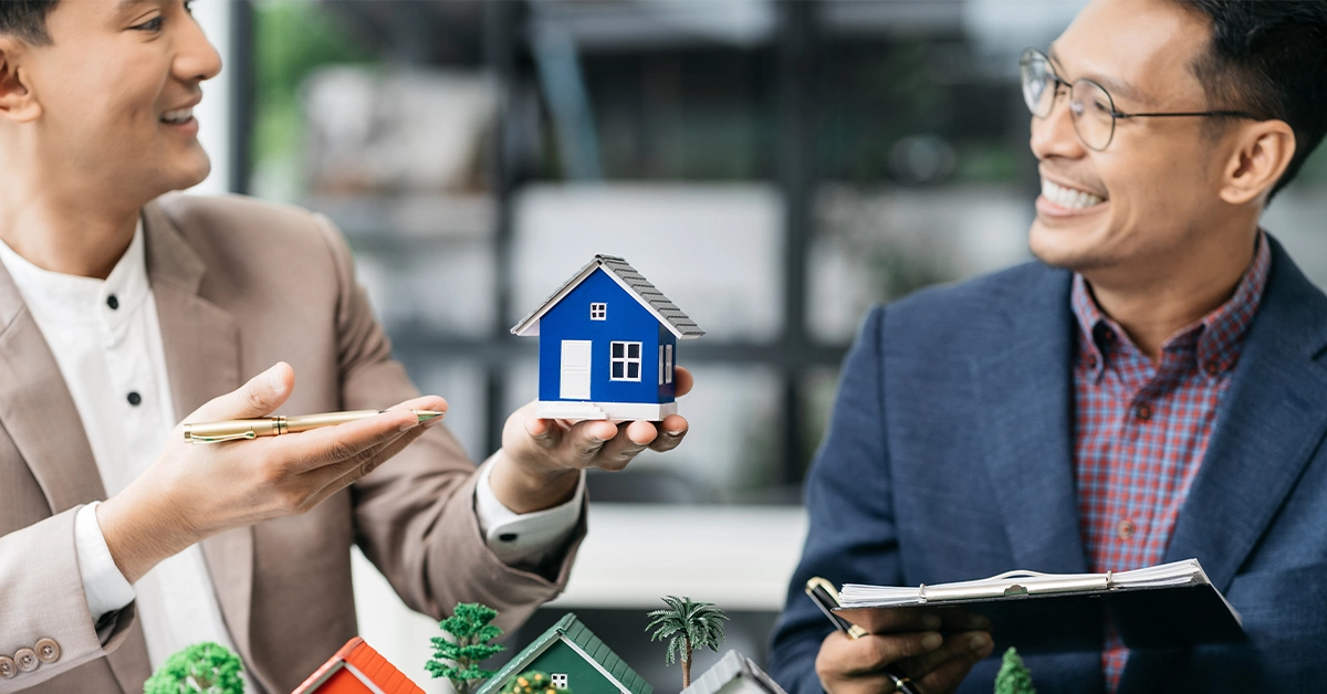  A real estate agent displaying models of under-construction projects 