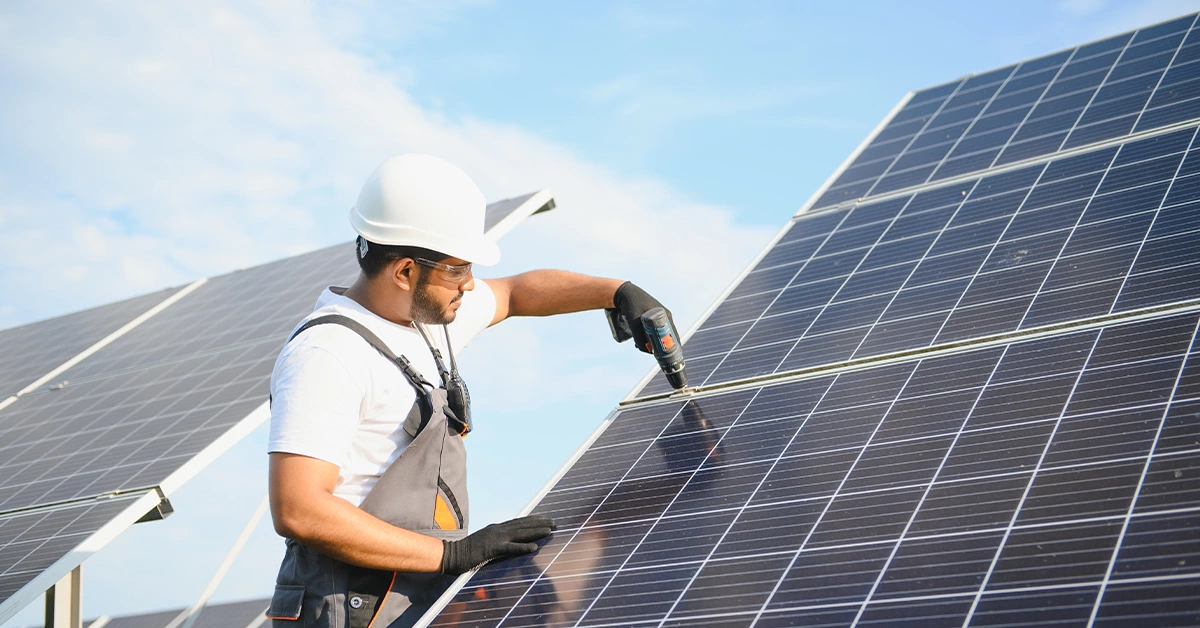 A worker installing solar panels