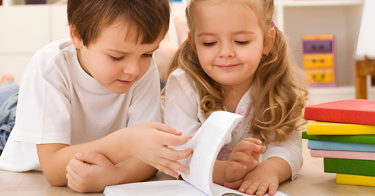 Children reading a book at Dewdrops Nursery in JLT