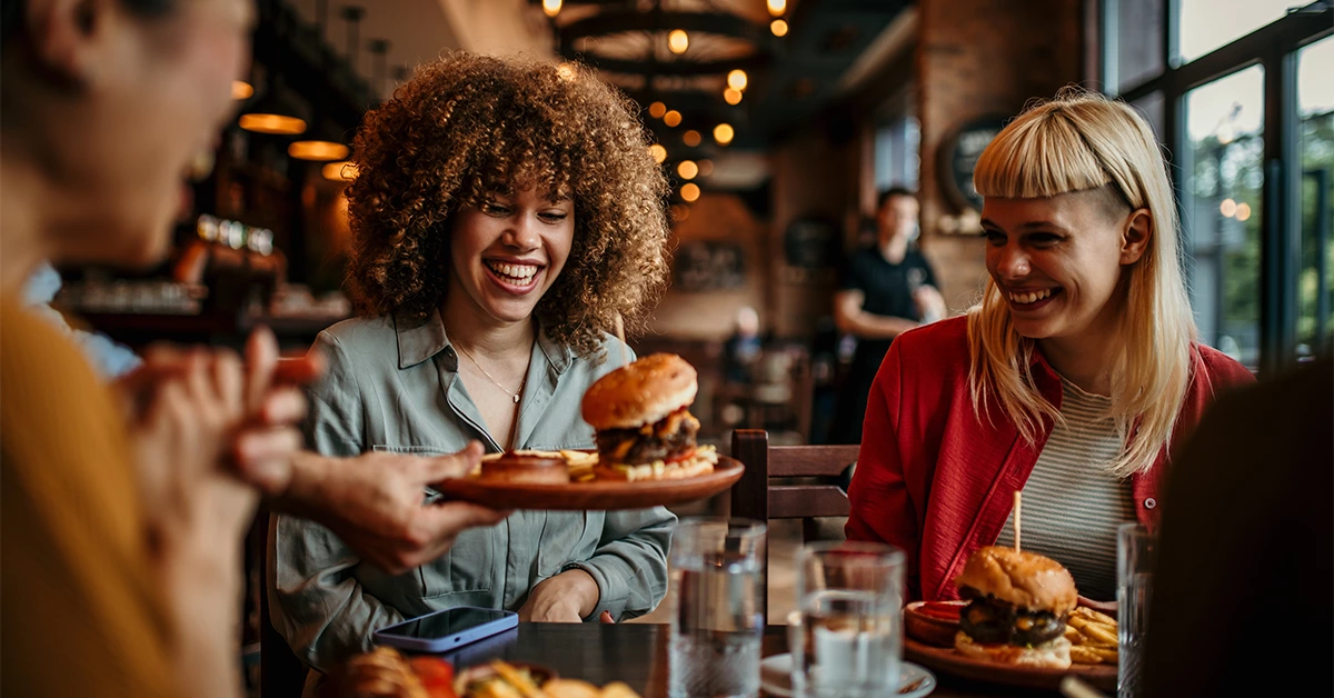 Group of friends enjoying food in a 24-hour restaurant