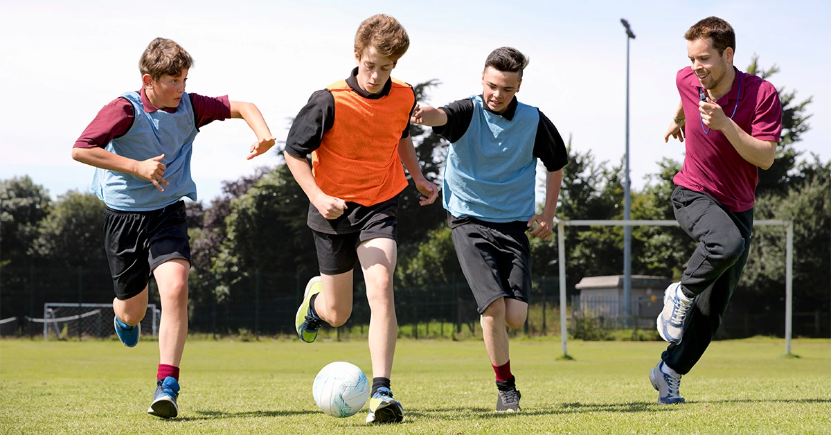 School boys playing football