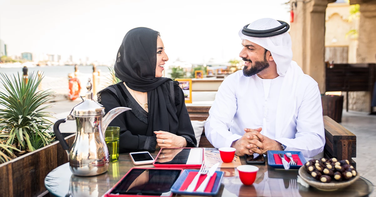 An Arabian couple enjoying a quick meal in a cafe in Dubai Creek 