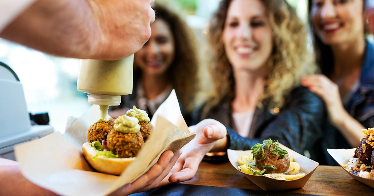 food truck serving tacos at a park